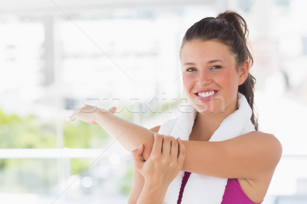 Stock photo: Portrait of a sporty woman stretching hand at yoga class