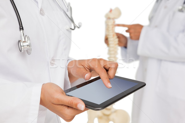 Mid section of doctors with digital table and skeleton model Stock photo © wavebreak_media