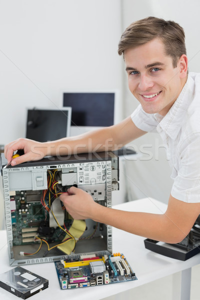 Young technician working on broken computer Stock photo © wavebreak_media