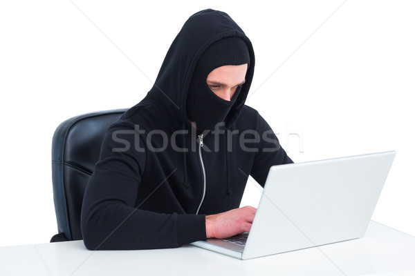 Stock photo: Hacker using laptop to steal identity