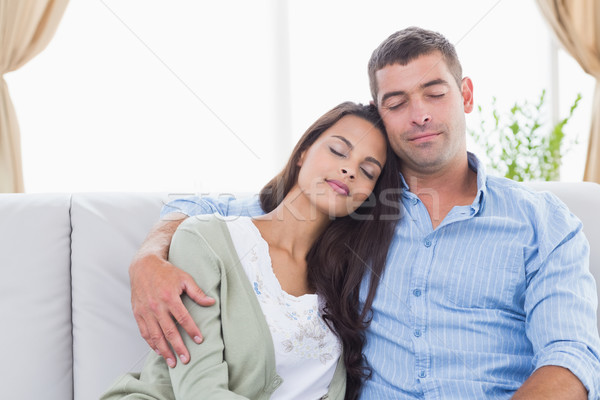 Couple with eyes closed sitting on sofa Stock photo © wavebreak_media