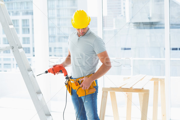 Repairman with drill machine in building Stock photo © wavebreak_media