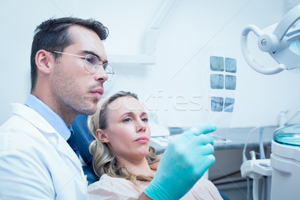 Dentist showing woman her mouth x-ray Stock photo © wavebreak_media