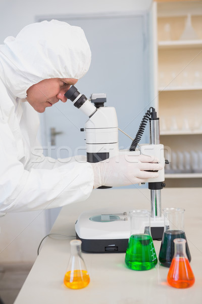 Scientist examining sample with microscope  Stock photo © wavebreak_media