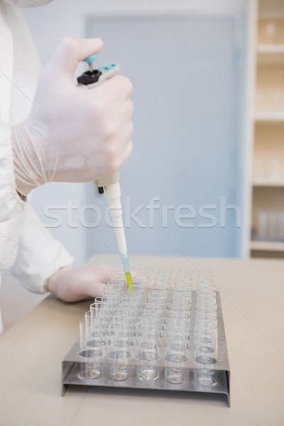 Scientist injecting tubes  Stock photo © wavebreak_media