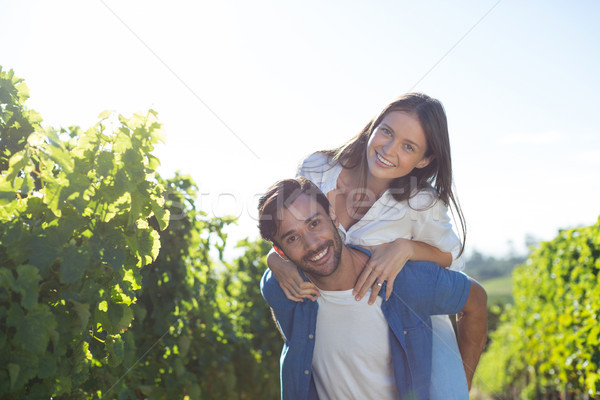 Happy young couple piggybacking during sunny day Stock photo © wavebreak_media