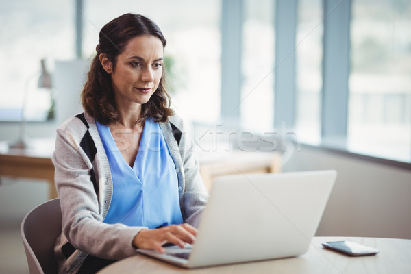 Attentive executive using laptop at desk Stock photo © wavebreak_media