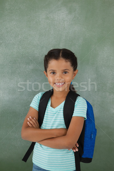 Portré aranyos iskolás lány áll keresztbe tett kar tábla Stock fotó © wavebreak_media