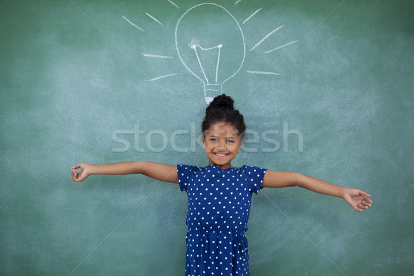 Portrait of girl with arms outstretched by bulb drawing on wall Stock photo © wavebreak_media