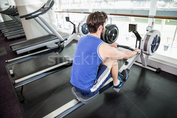 Jóképű férfi testmozgás rajz gép tornaterem férfi Stock fotó © wavebreak_media