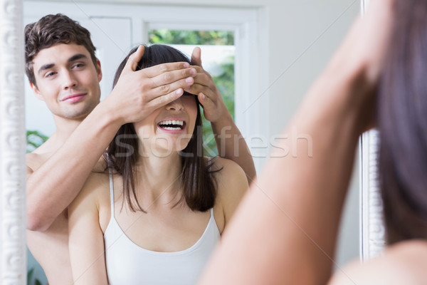 Homme yeux permanent salle de bain miroir maison [[stock_photo]] © wavebreak_media