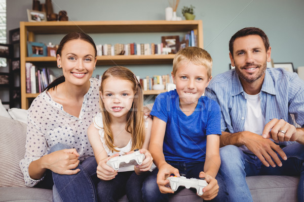 Smiling children playing video games with parents Stock photo © wavebreak_media