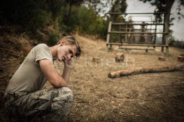 Tired soldier with hand on head sitting  Stock photo © wavebreak_media