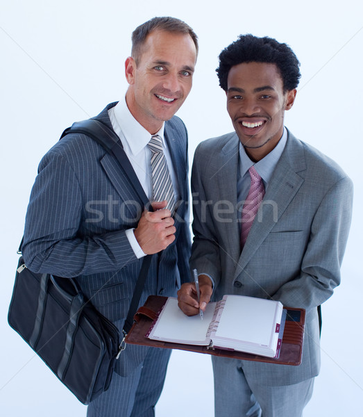 Sonriendo empresarios escrito negocios diario Foto stock © wavebreak_media