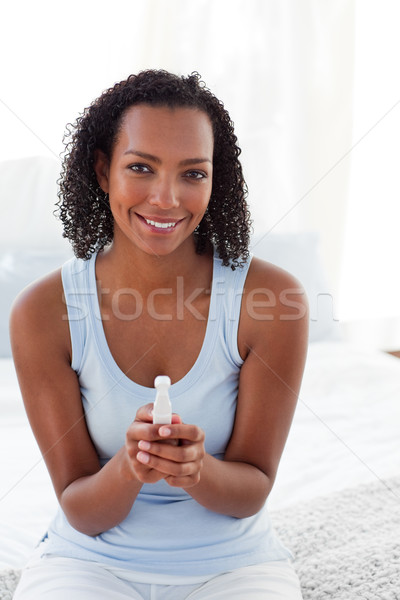 Smiling woman finding out results of a pregnancy test  Stock photo © wavebreak_media