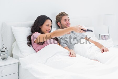 Jolly couple drinking coffee lying in the bed Stock photo © wavebreak_media