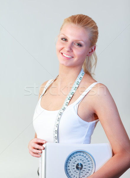 Beautiful woman holding a scales focus on woman  Stock photo © wavebreak_media