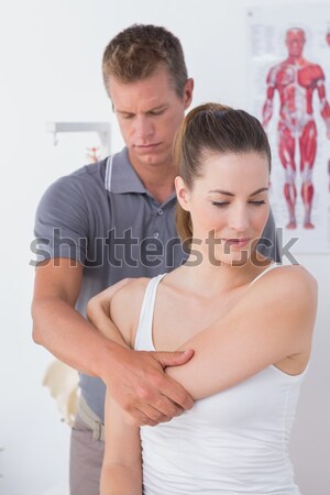 Stock photo: Hispanic man doing a massage to his beautiful wife on their bed 