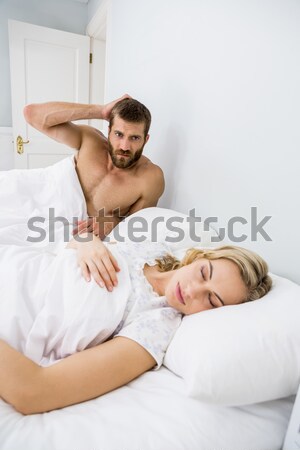 Portrait of a man kissing his fiance in their bedroom Stock photo © wavebreak_media