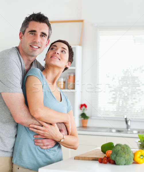 Happy husband and wife hugging in a kitchen Stock photo © wavebreak_media