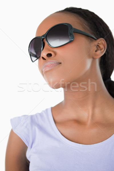 Close up of young woman wearing her sunglasses against a white background Stock photo © wavebreak_media