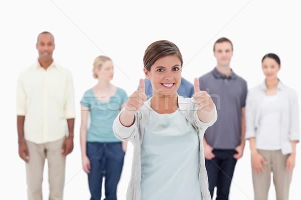 Mulher sorrindo pessoas atrás branco mão Foto stock © wavebreak_media