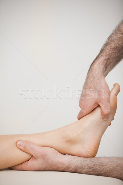 Side view of a foot being touched by a doctor in a room Stock photo © wavebreak_media