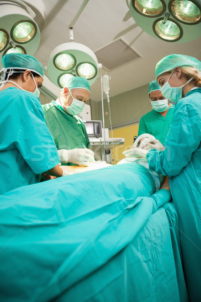 Medical team operating a patient in a surgical room Stock photo © wavebreak_media