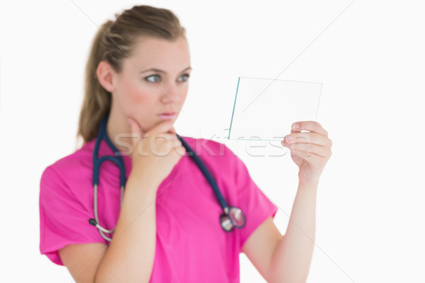 Female doctor looking at the pane while being thoughtful Stock photo © wavebreak_media