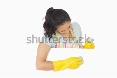 Happy woman with blue rag leaning on white surface wearing rubber gloves and apron Stock photo © wavebreak_media