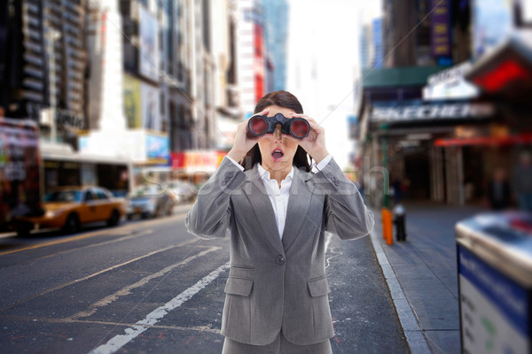 Stock photo: Composite image of surprised businesswoman looking through binoc