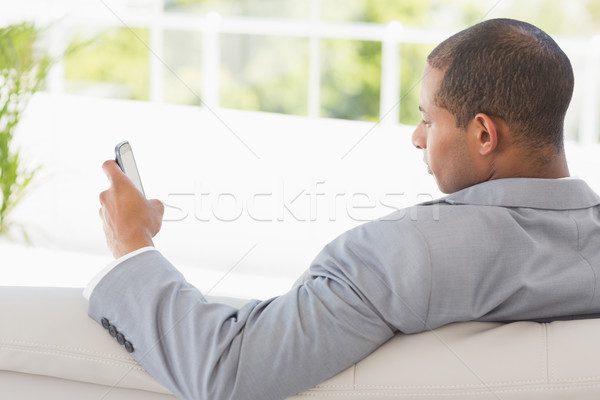 Stock photo: Businessman reading a text on the couch 