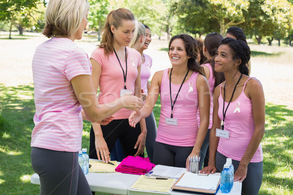 Volunteer greeting participants during breast cancer awareness Stock photo © wavebreak_media