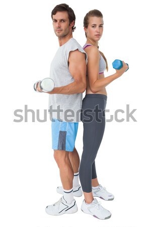 Portrait of a fit young couple exercising with dumbbell Stock photo © wavebreak_media