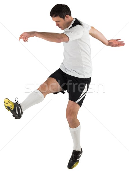 Stock photo: Football player in white kicking