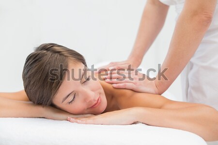 Stock photo: Attractive woman receiving shoulder massage at spa center