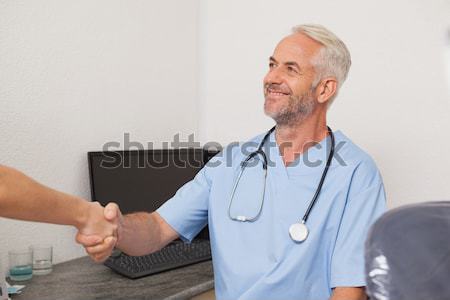 Dentist shaking hands with his patient Stock photo © wavebreak_media