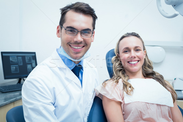 Stock photo: Dentist examining young womans teeth