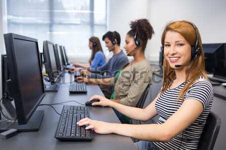 Happy student in computer class smiling at camera Stock photo © wavebreak_media