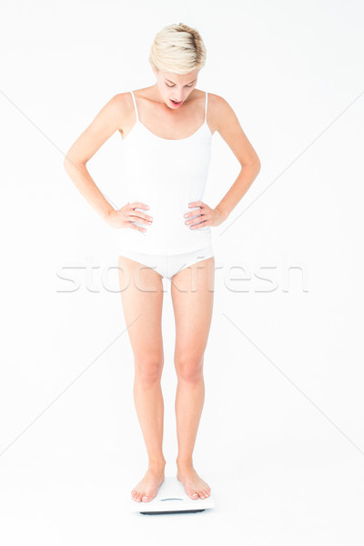 Blonde woman standing on weighing scales  Stock photo © wavebreak_media