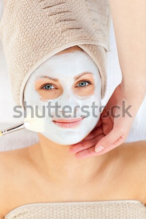 Stock photo: Attractive woman having white cream on her face