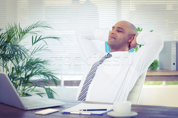 Relaxed businessman lying down in swivel chair Stock photo © wavebreak_media