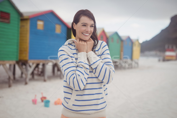 Smiling woman standing at beach Stock photo © wavebreak_media