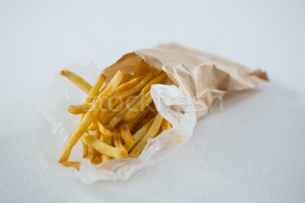 Сток-фото: картофель · фри · таблице · бумаги · белый · улыбаясь