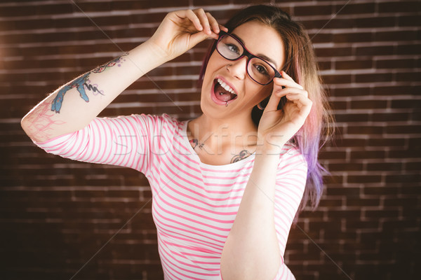 Portrait femme souriante mur de briques femme [[stock_photo]] © wavebreak_media