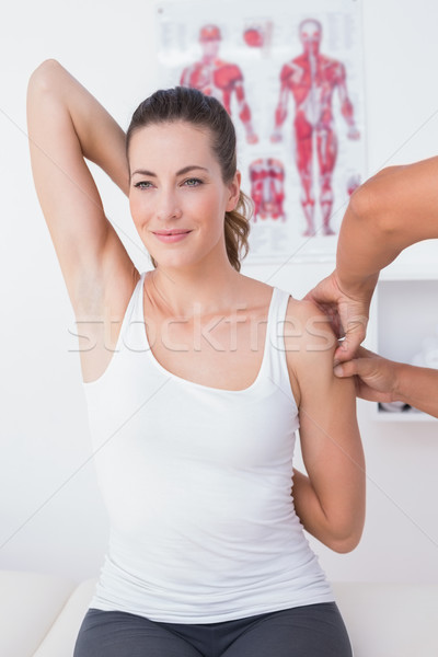 Stock photo: Doctor examining his patient arm