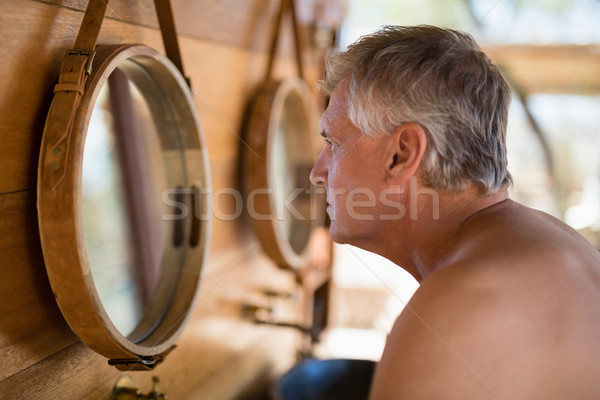 Man looking at mirror in cottage Stock photo © wavebreak_media