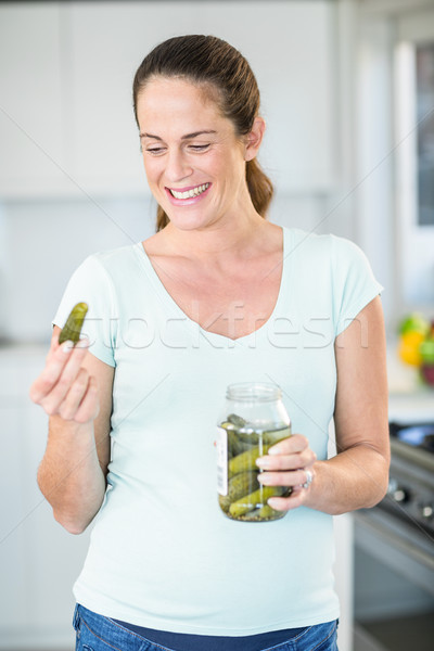 Happy woman looking at pickle Stock photo © wavebreak_media