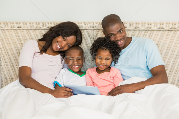 Family with digital tablet in bed Stock photo © wavebreak_media