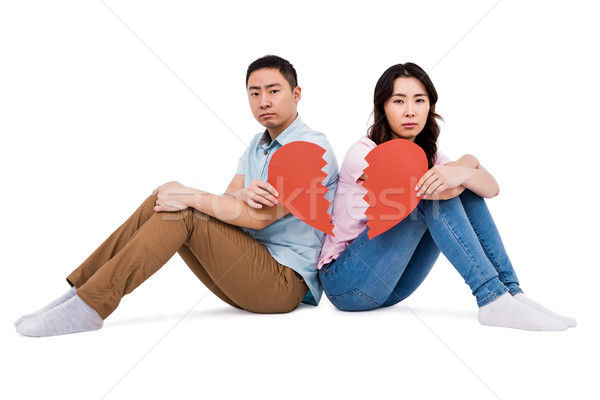 Portrait of sad couple holding broken heart pieces Stock photo © wavebreak_media